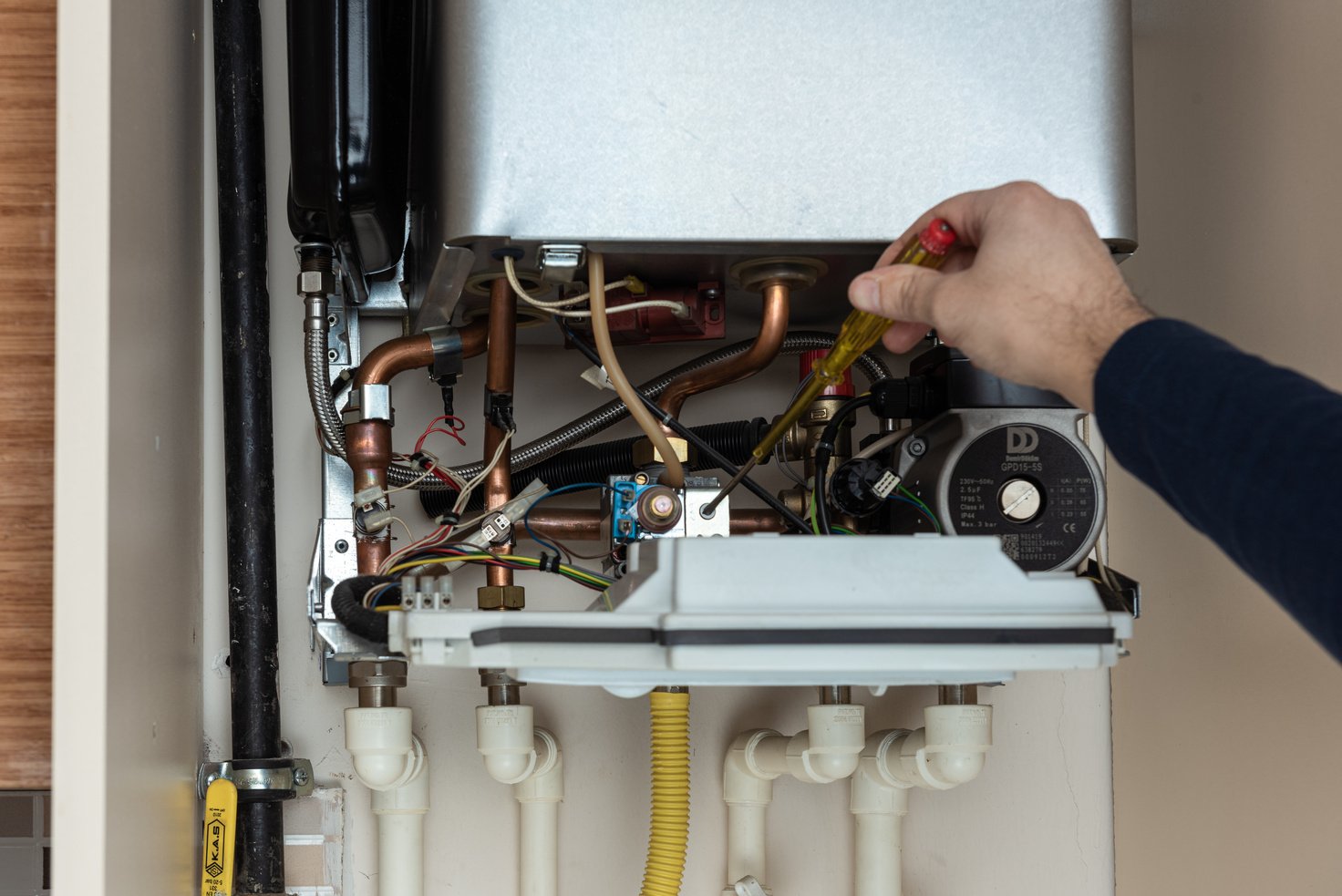 Close up of opened combi gas boiler for repair.